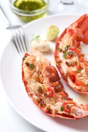 Photo of Delicious lobster tails with green onion on white table, closeup