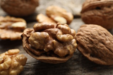 Fresh walnuts with shells on table, closeup