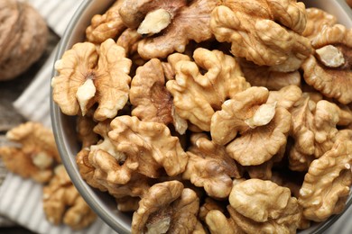 Photo of Fresh walnuts in bowl on table, top view