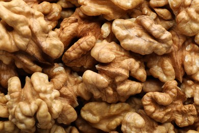 Photo of Pile of fresh ripe walnuts as background, top view