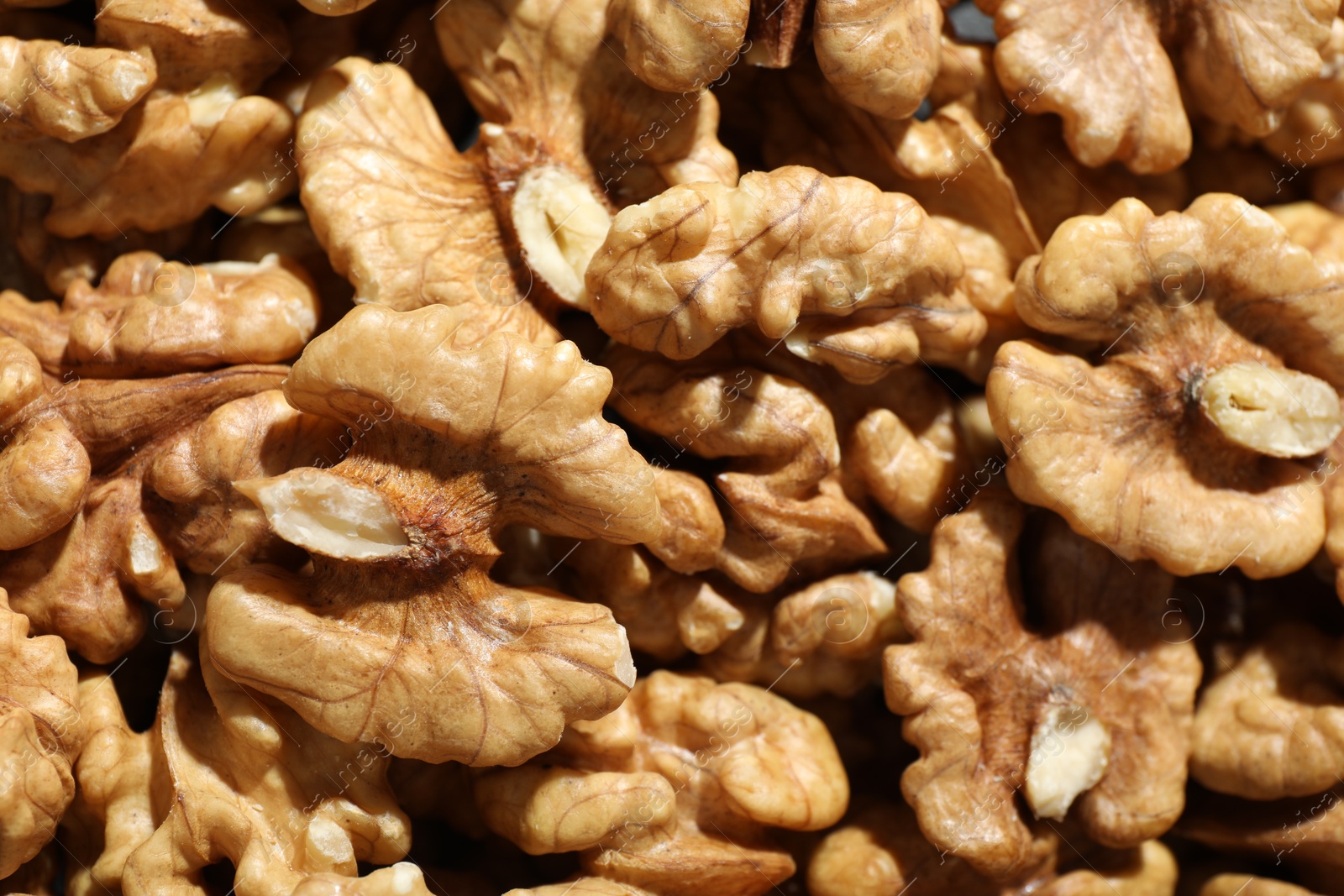 Photo of Pile of fresh ripe walnuts as background, top view