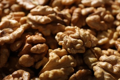 Photo of Pile of fresh ripe walnuts as background, closeup