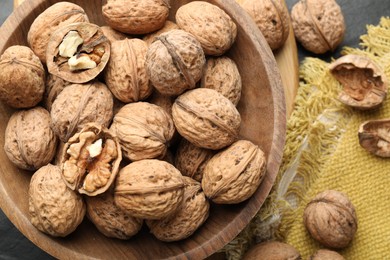 Photo of Fresh walnuts in shells on table, flat lay