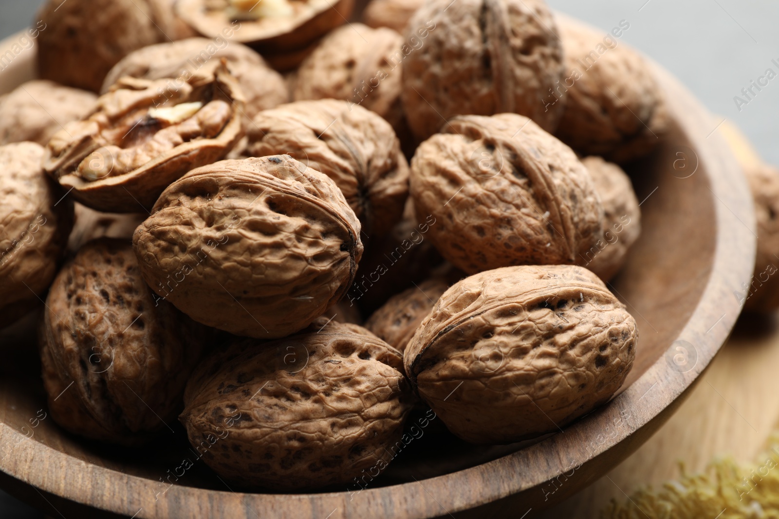 Photo of Fresh walnuts in shells on table, closeup