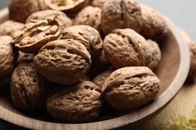 Photo of Fresh walnuts in shells on table, closeup