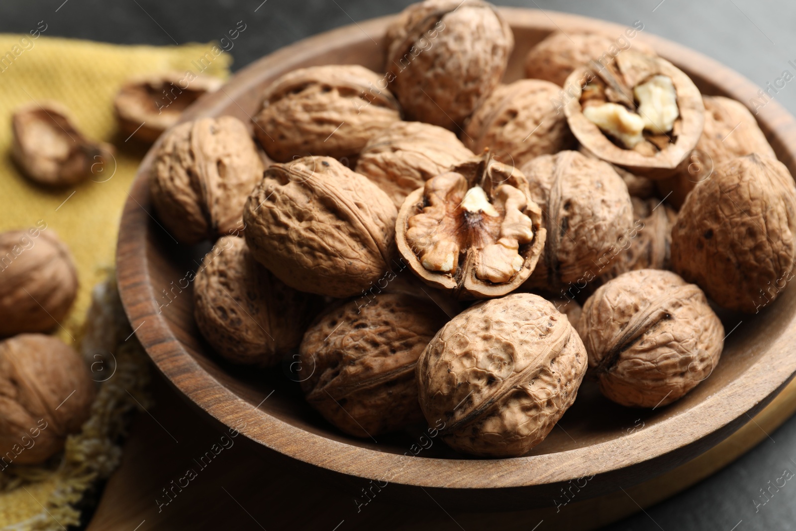 Photo of Fresh walnuts in shells on table, closeup