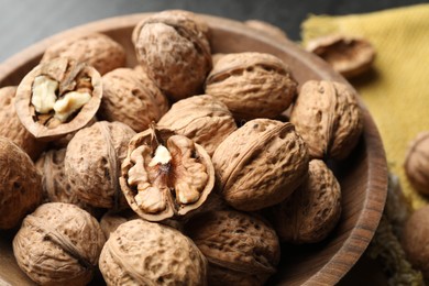 Photo of Fresh ripe walnuts in shells on table, closeup