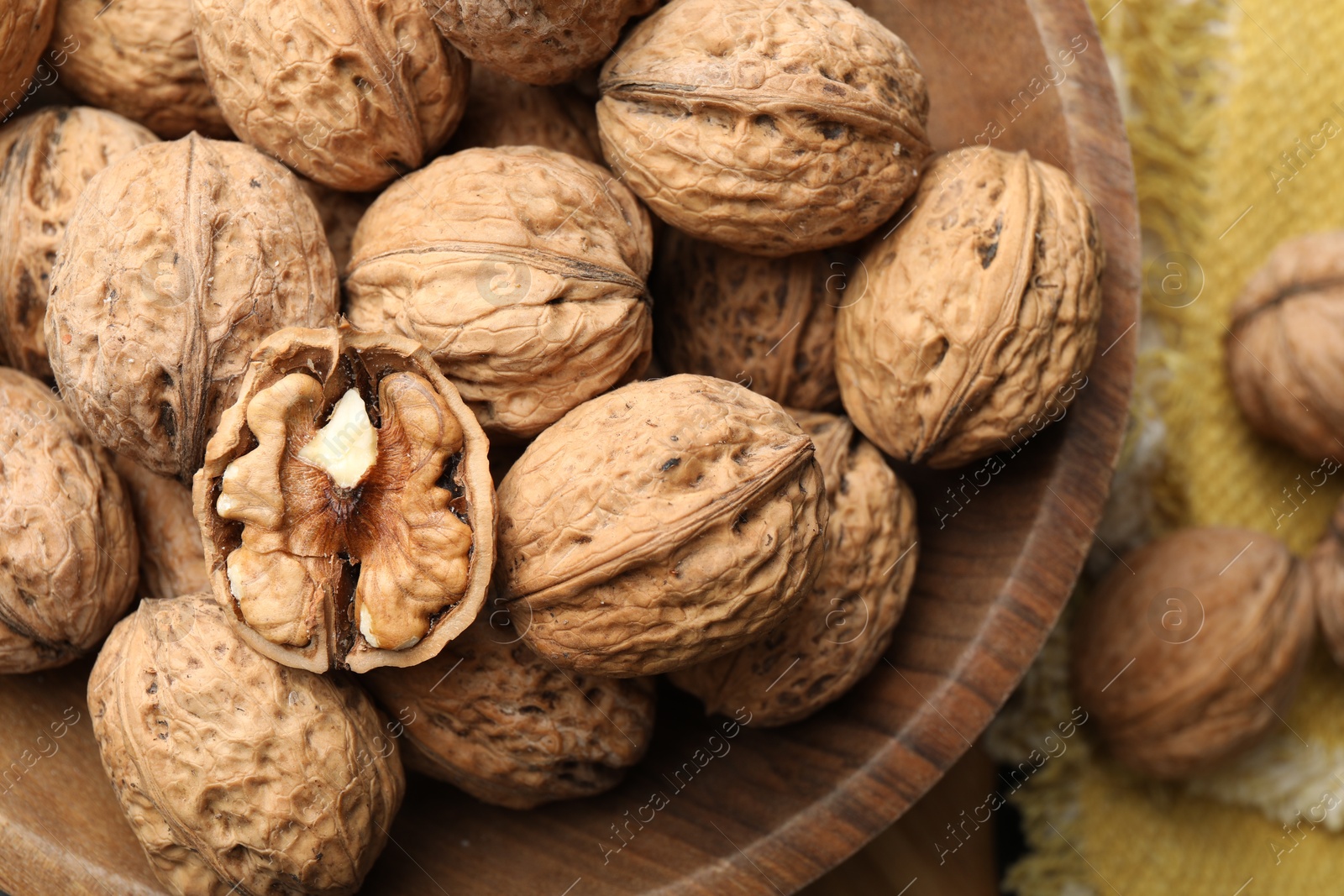 Photo of Fresh ripe walnuts in shells on table, top view