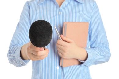 Photo of Journalist with microphone, notebook and pen on white background, closeup