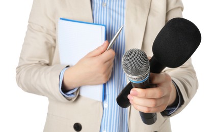 Photo of Journalist with microphones, notebook and pen on white background, closeup