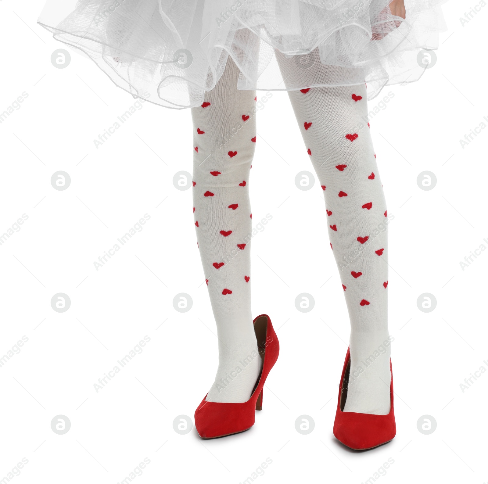 Photo of Little girl wearing oversized high heeled shoes on white background, closeup