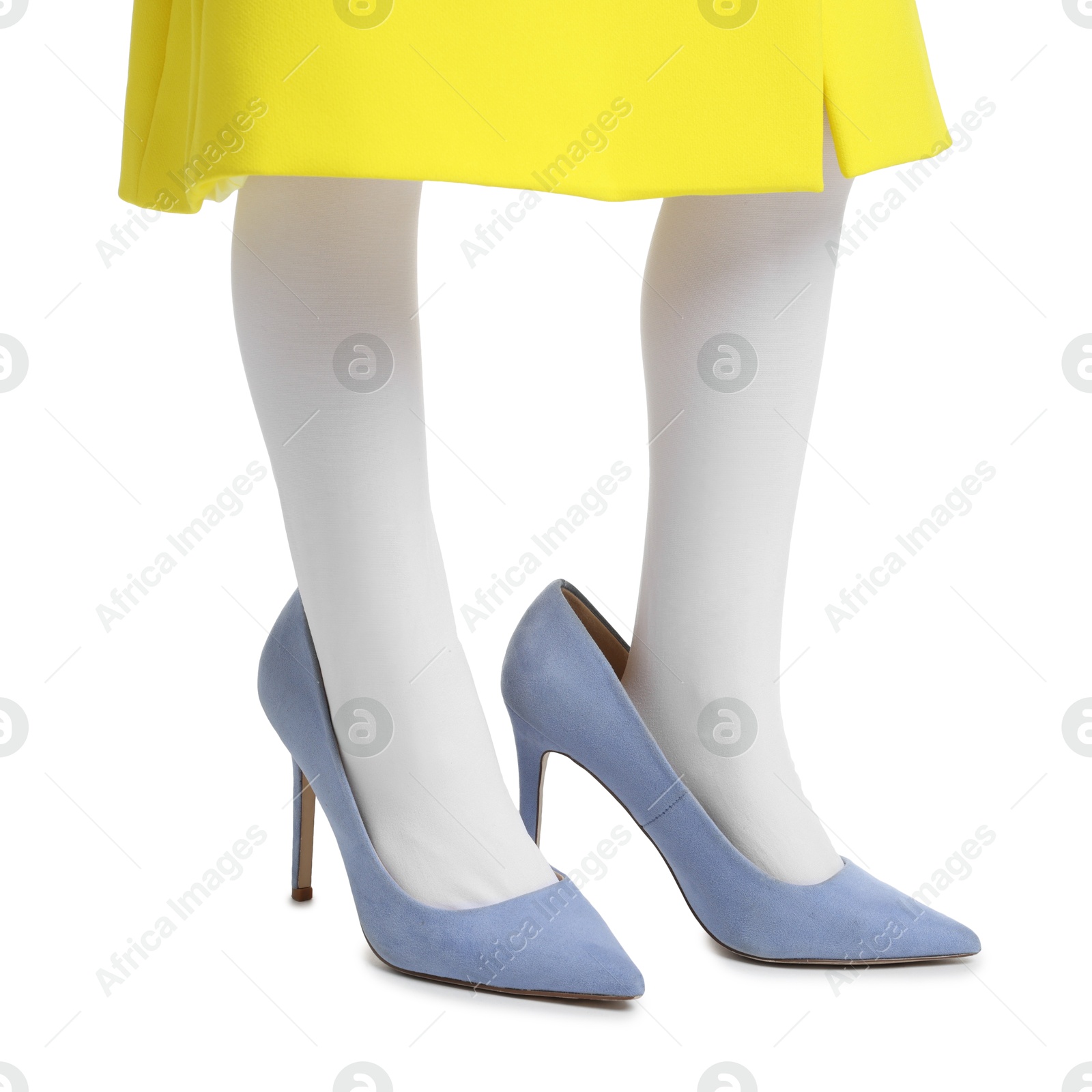 Photo of Little girl wearing oversized high heeled shoes on white background, closeup