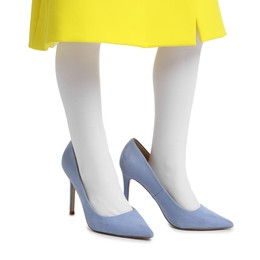 Photo of Little girl wearing oversized high heeled shoes on white background, closeup