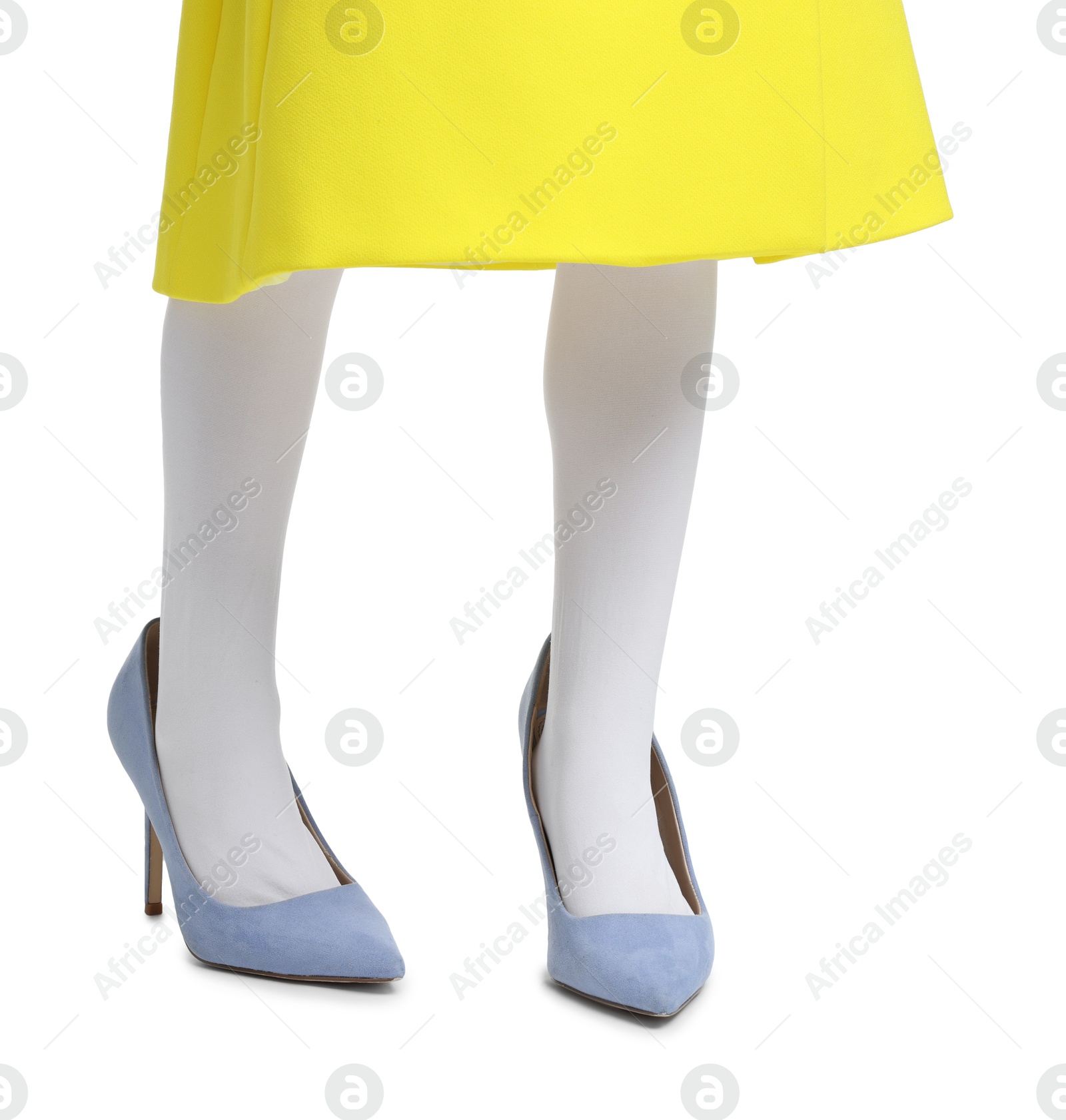 Photo of Little girl wearing oversized high heeled shoes on white background, closeup