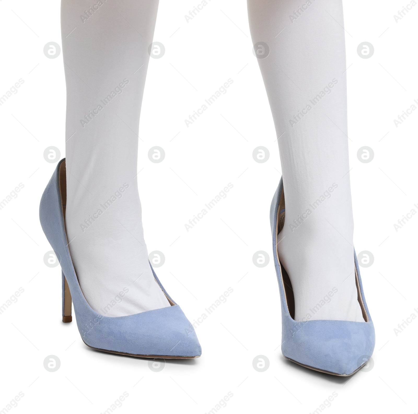 Photo of Little girl wearing oversized high heeled shoes on white background, closeup