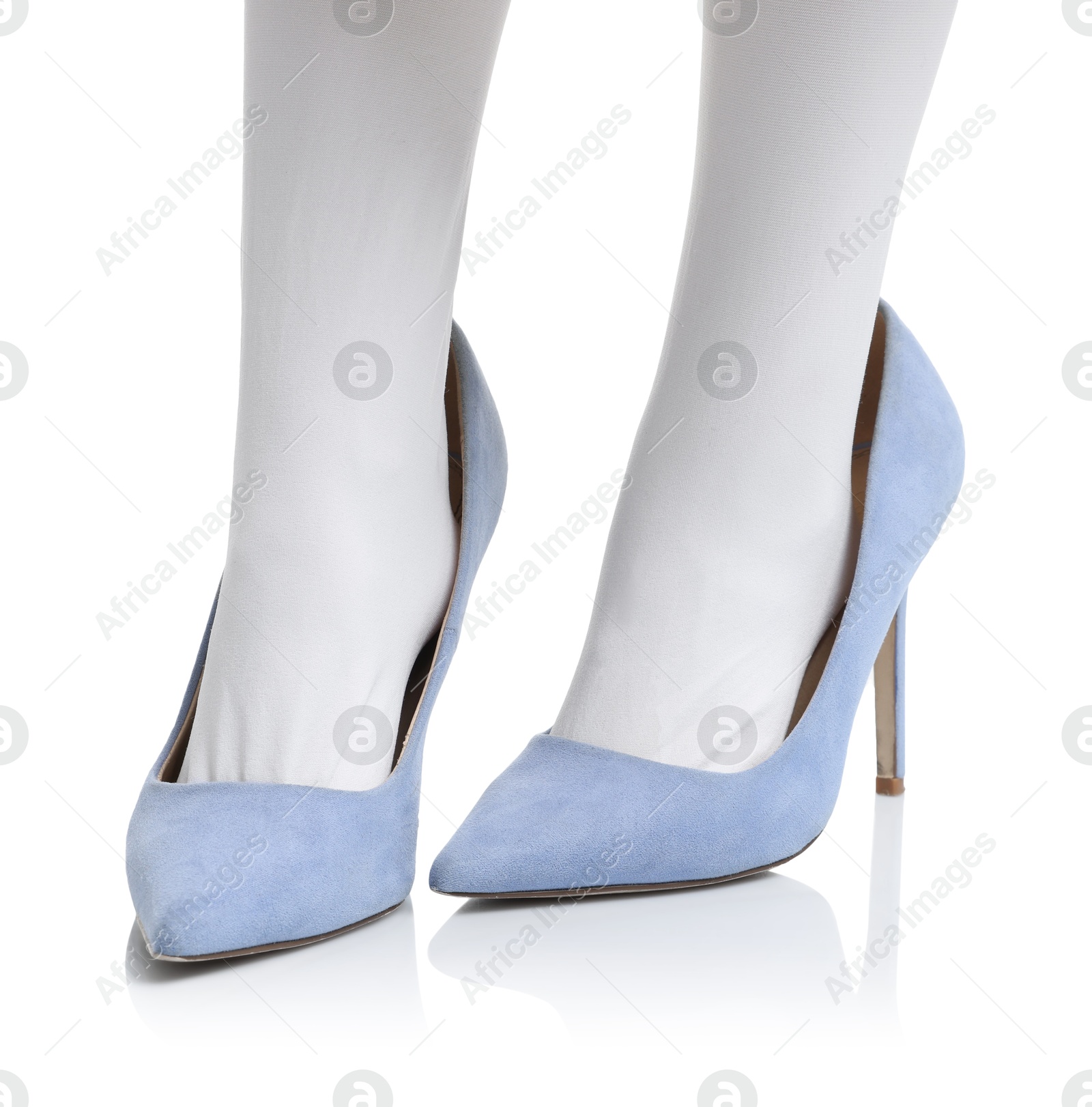 Photo of Little girl wearing oversized high heeled shoes on white background, closeup