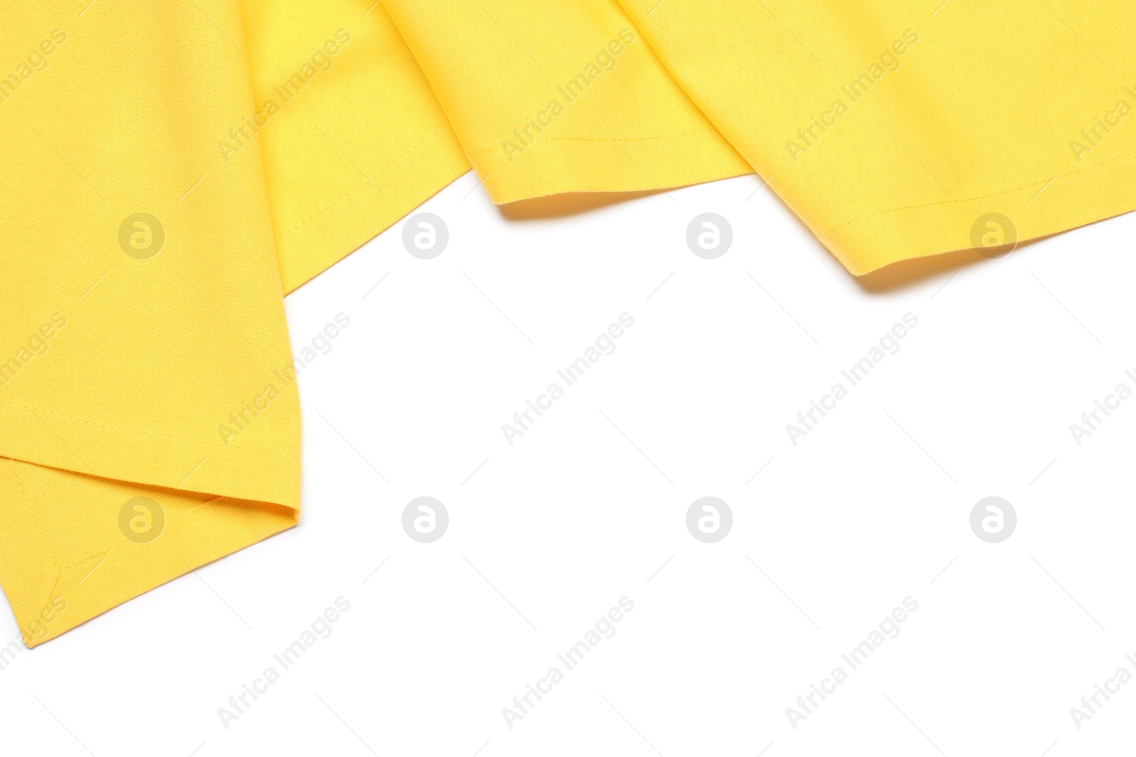 Photo of Yellow tablecloth isolated on white, top view