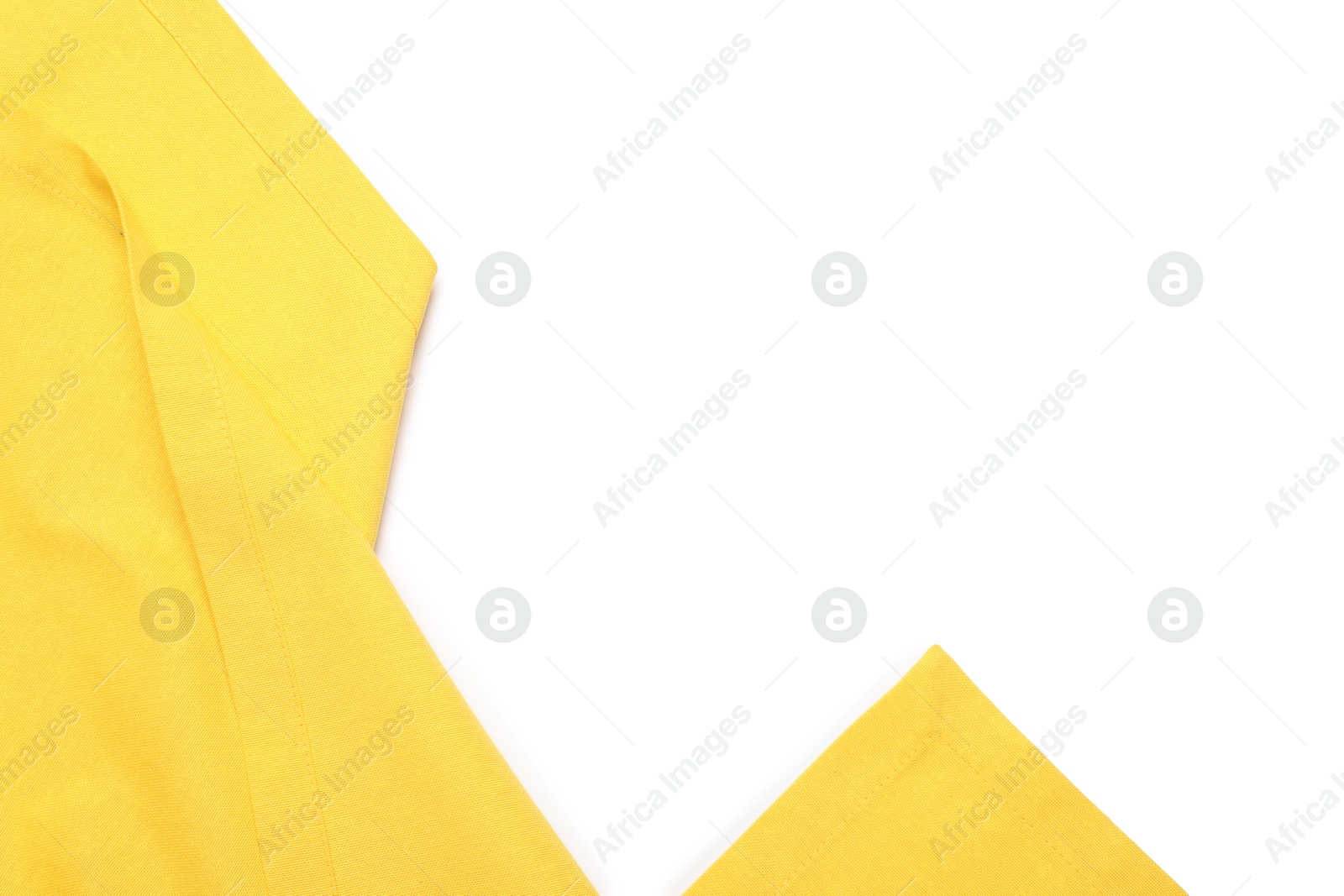 Photo of Yellow tablecloth isolated on white, top view