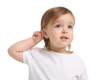 Photo of Cute little baby girl showing her ear on white background