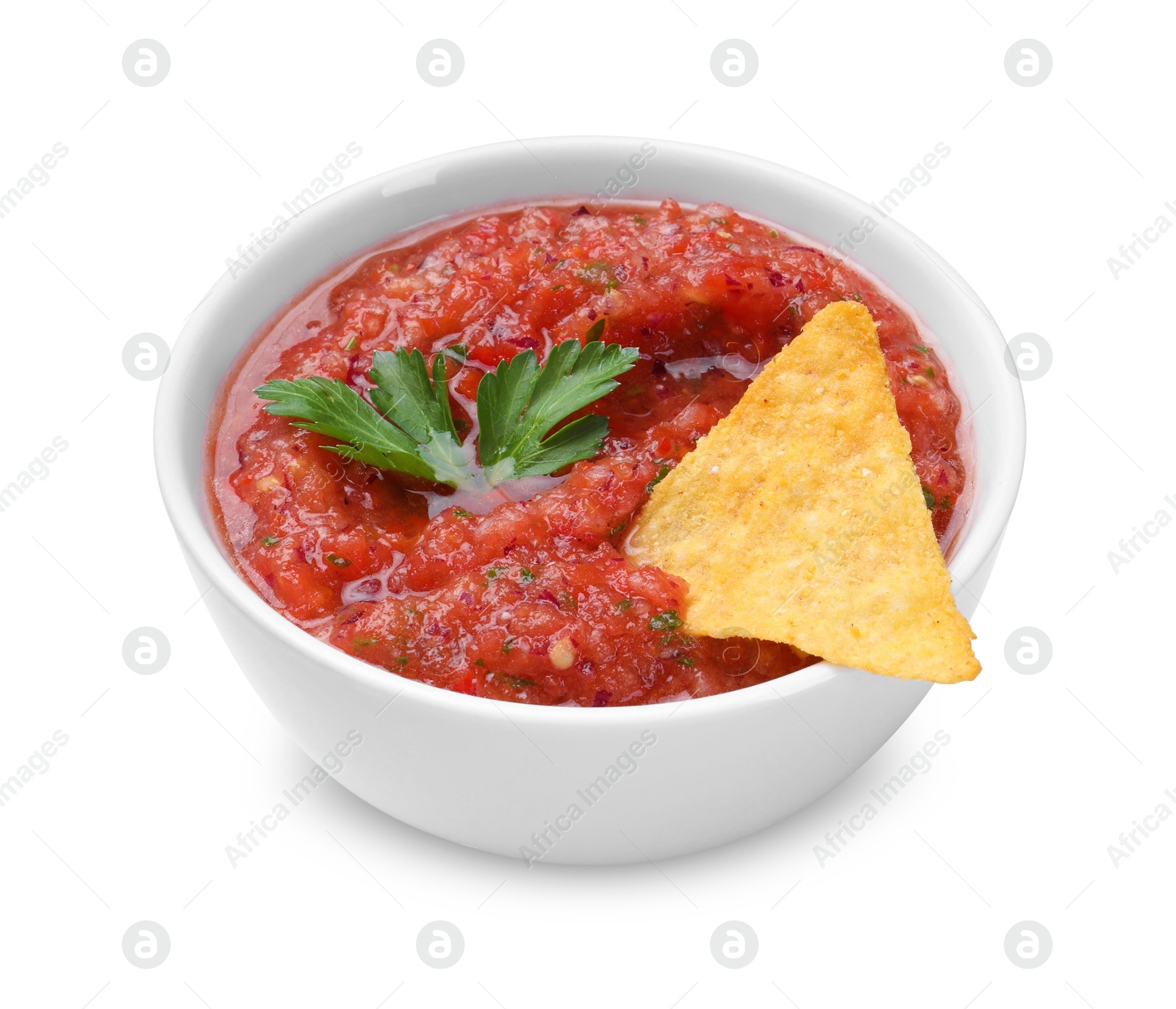 Photo of Delicious spicy salsa sauce with nacho chip in bowl isolated on white