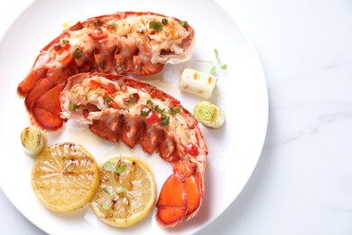 Photo of Delicious lobster tails with lemon, microgreens and green onion on white marble table, top view. Space for text