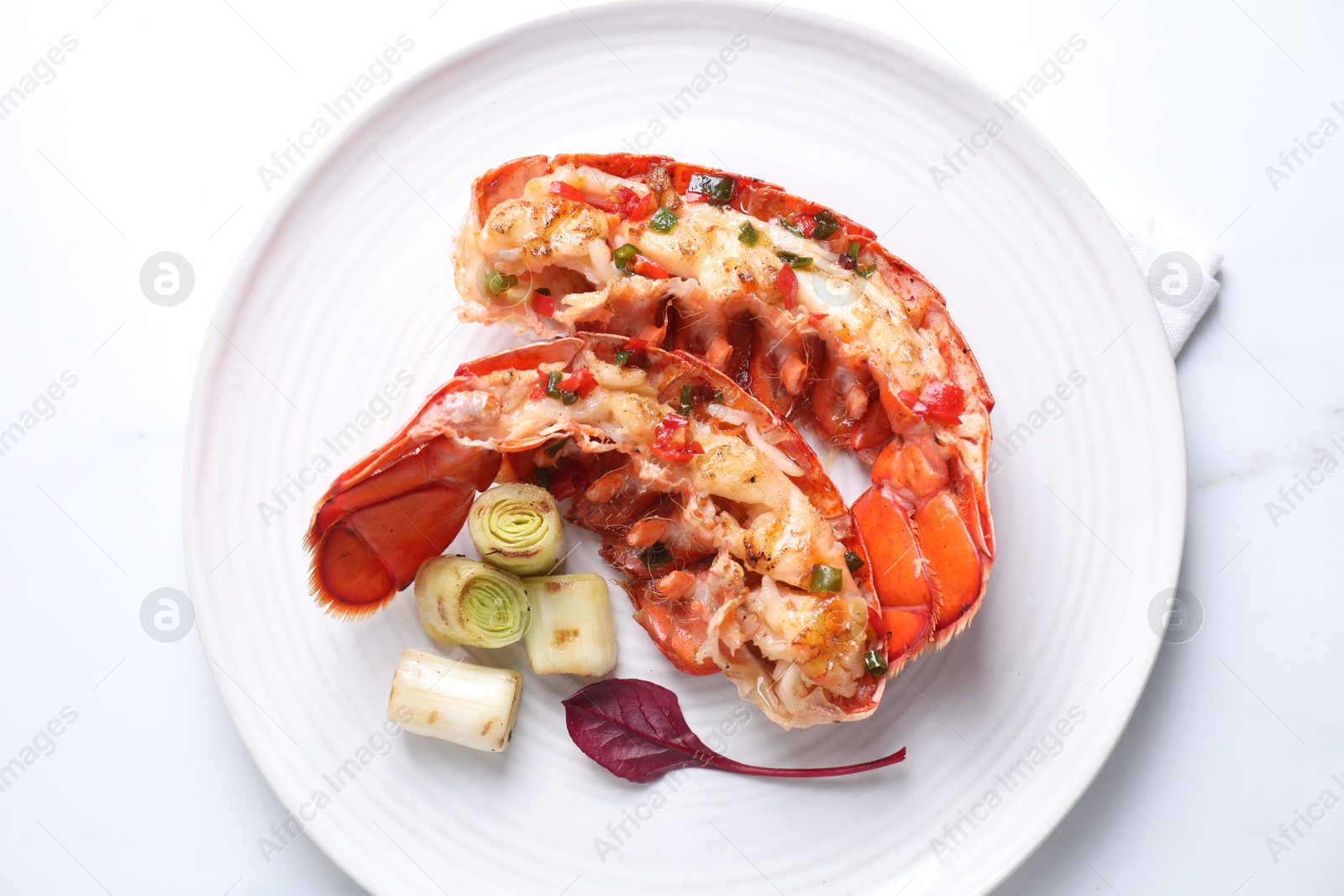 Photo of Delicious lobster tails with green onion on white table, top view