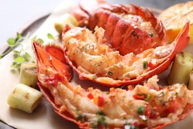 Photo of Delicious lobster tails with microgreens and green onion on table, closeup