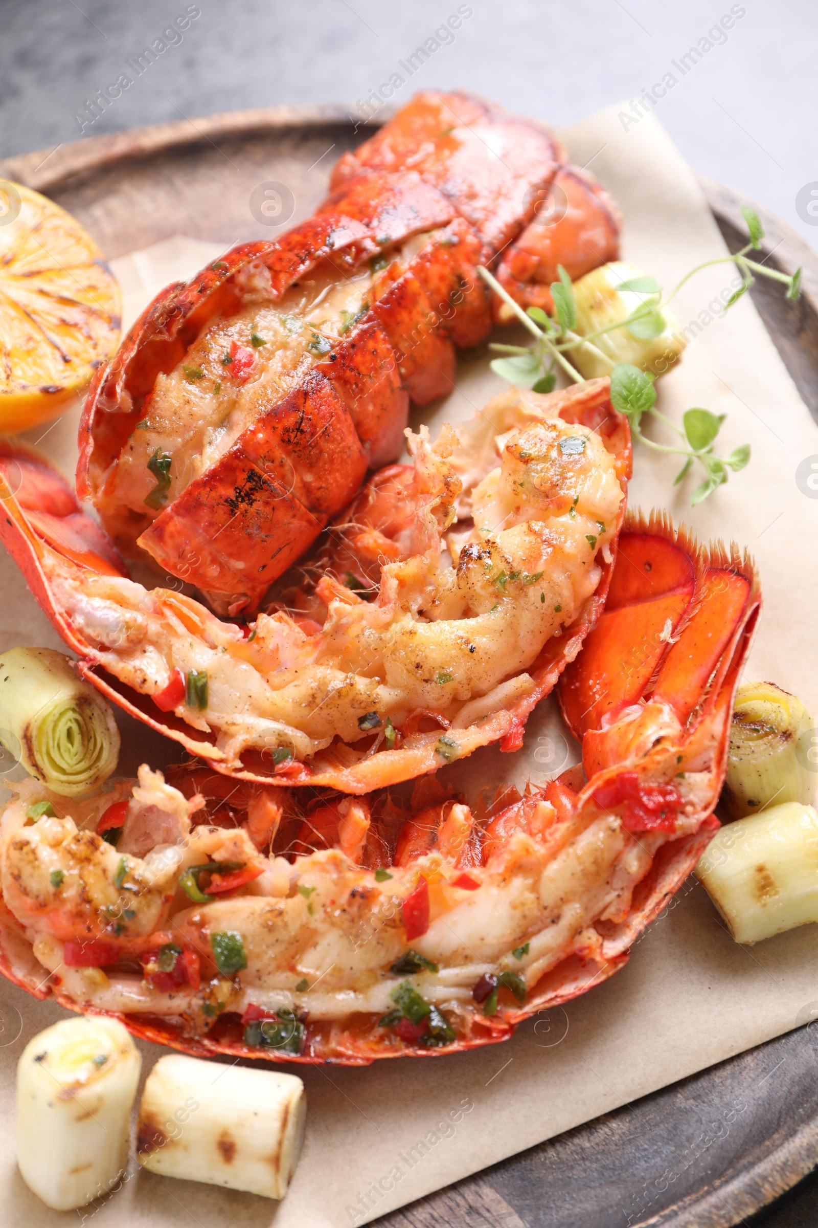 Photo of Delicious lobster tails with microgreens and green onion on table, above view