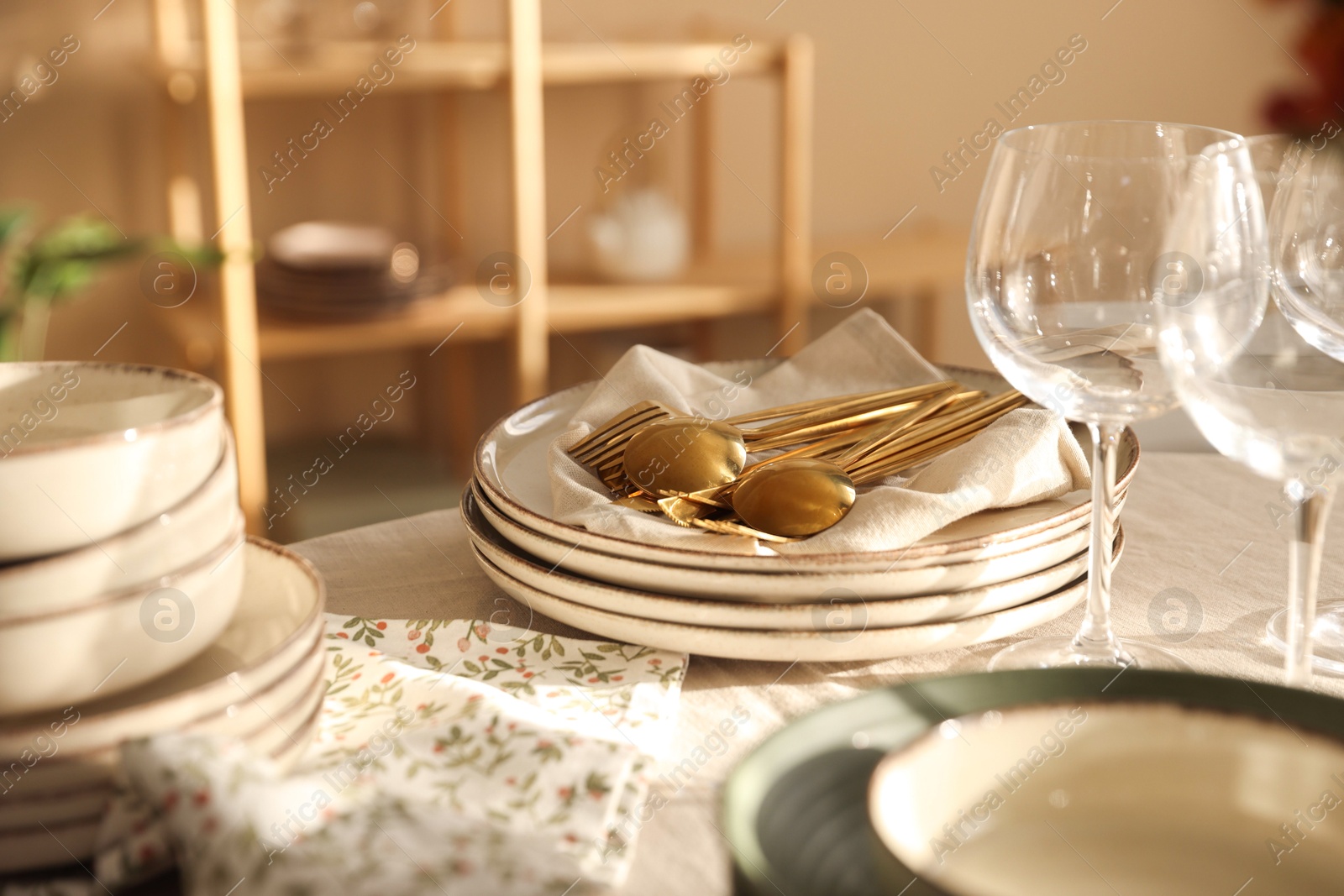 Photo of Stylish table setting with dishware, glasses and cutlery indoors