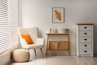 Photo of Stylish room interior with console table near white wall