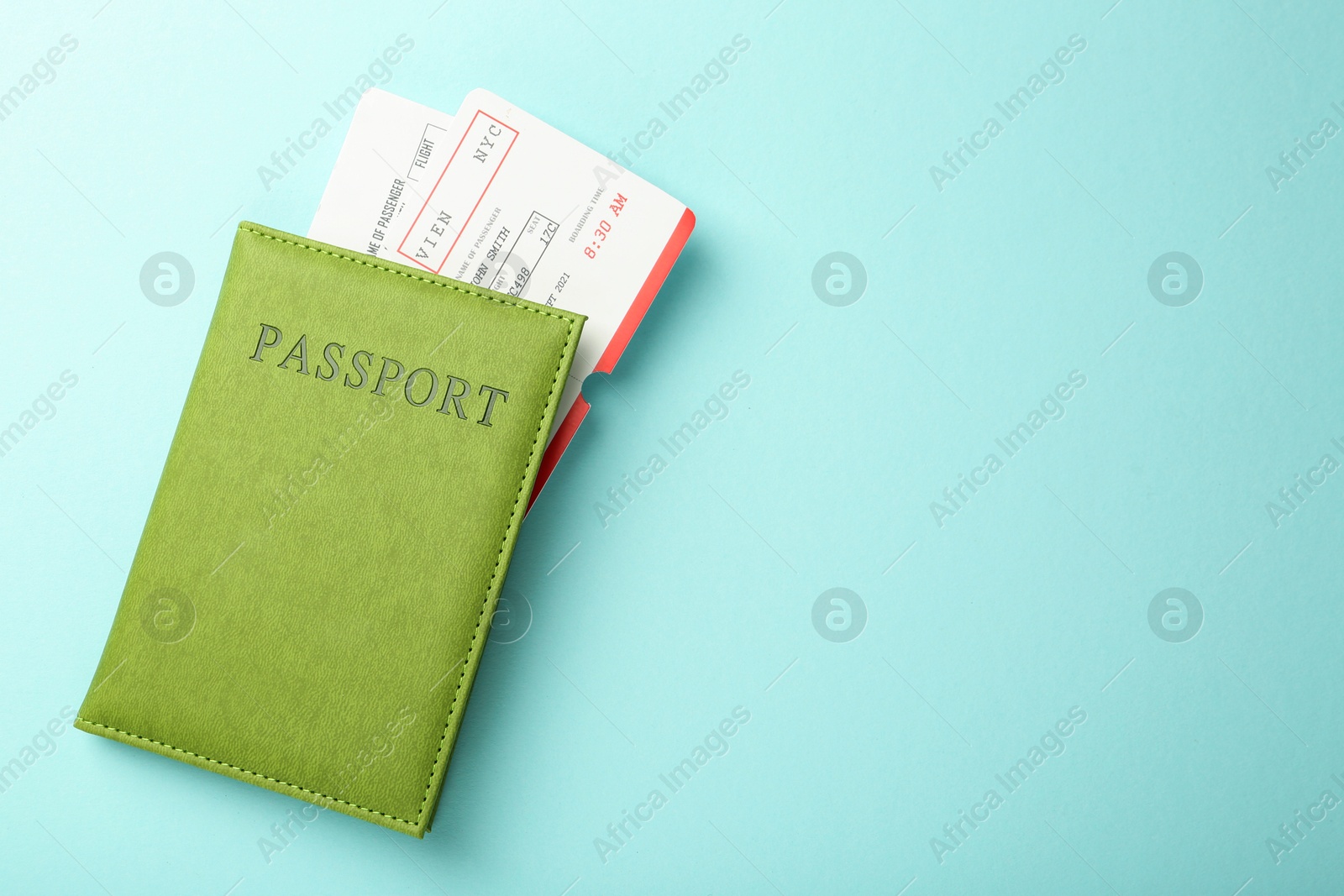 Photo of Passport with tickets on light blue background, top view. Space for text