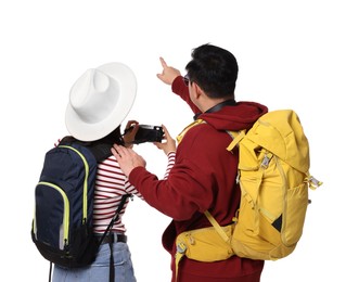 Photo of Travellers with backpacks taking photo on white background, back view