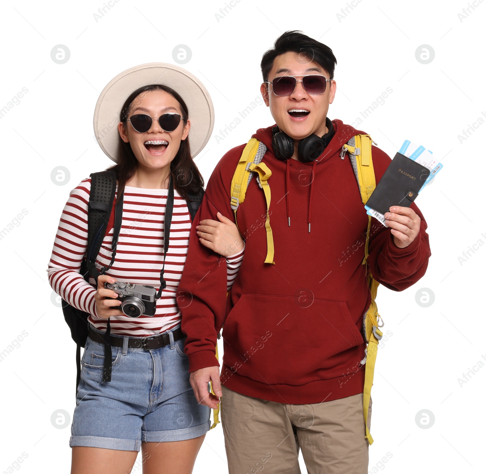 Photo of Happy travellers with passports and camera on white background