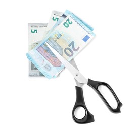 Photo of Euro banknotes and scissors isolated on white, top view