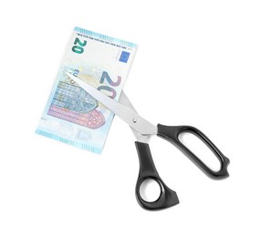 Photo of Scissors with euro banknote isolated on white, top view