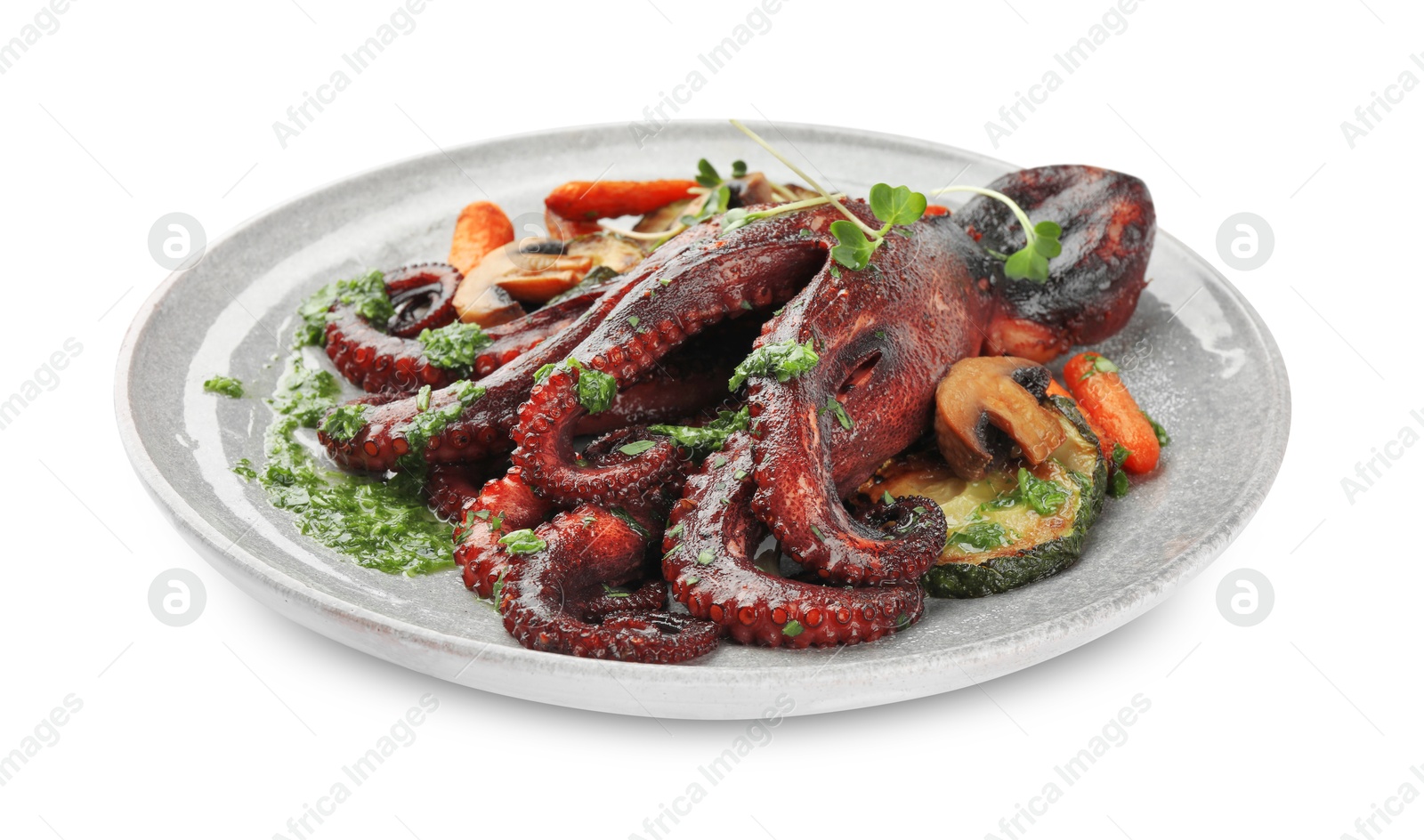 Photo of Roasted octopus with vegetables and mushrooms isolated on white