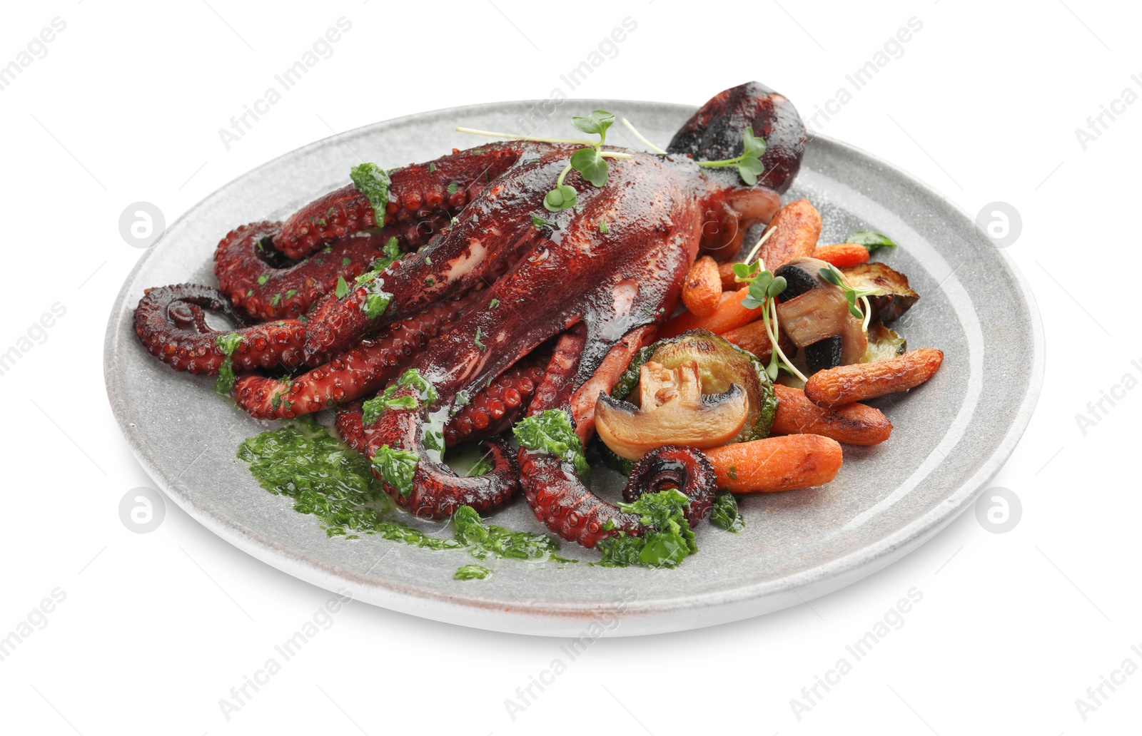 Photo of Roasted octopus with vegetables and mushrooms isolated on white