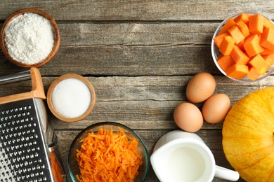 Photo of Different ingredients for pumpkin pancakes on wooden table, flat lay. Space for text