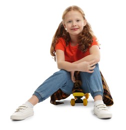 Photo of Stylish little girl sitting on penny board against white background