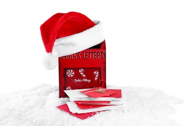 Photo of Santa Claus mail box with hat and letters on artificial snow against white background, space for text. Christmas tradition