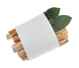 Photo of Palo santo sticks wrapped in paper and green leaves on white background