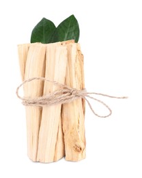 Photo of Bunch of palo santo sticks and green leaves on white background