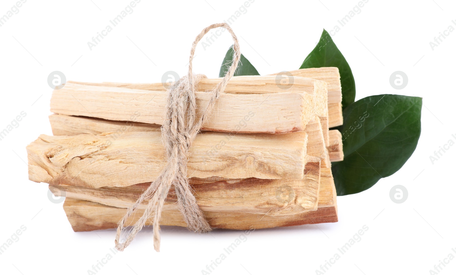 Photo of Bunch of palo santo sticks and green leaves on white background