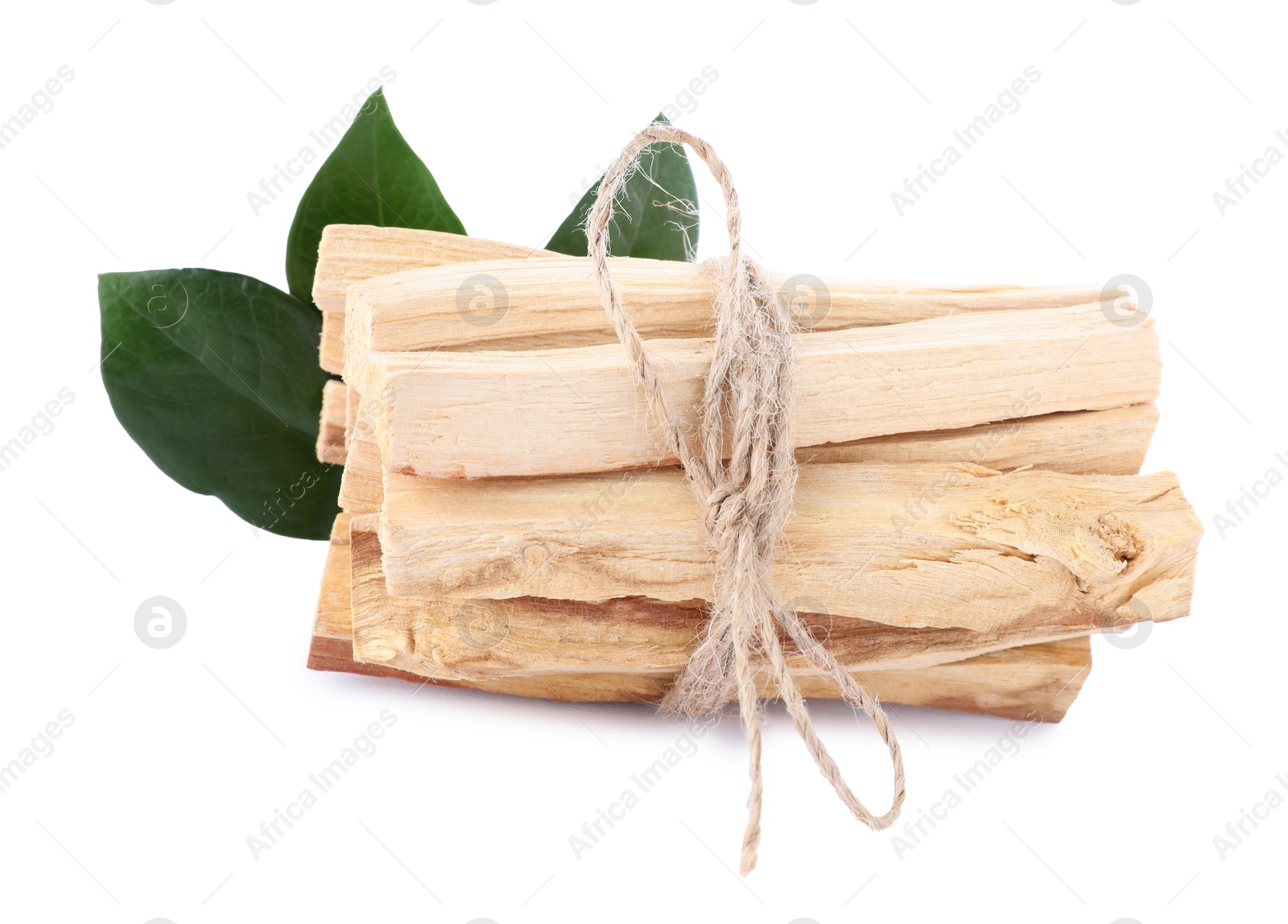 Photo of Bunch of palo santo sticks and green leaves on white background