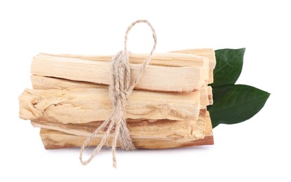 Photo of Bunch of palo santo sticks and green leaves on white background