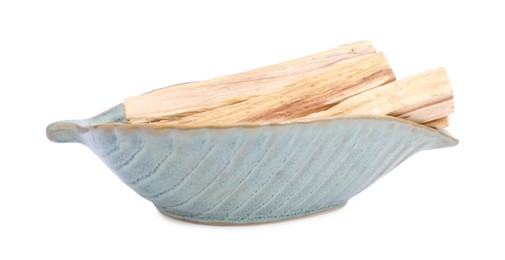 Photo of Palo santo sticks in ceramic bowl on white background