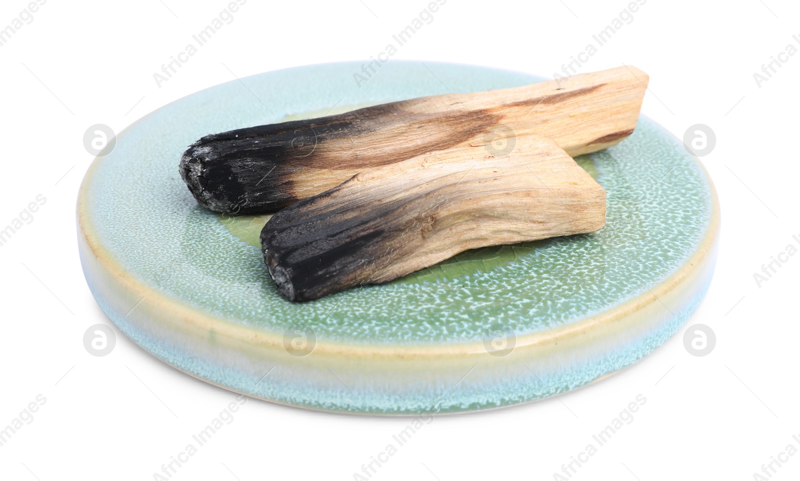 Photo of Burnt palo santo sticks on white background