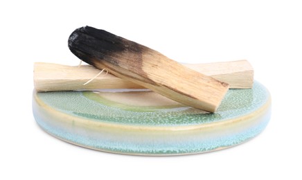 Photo of Whole palo santo stick and burnt one on white background