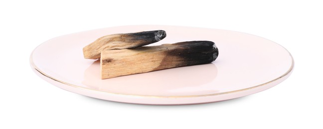 Photo of Burnt palo santo sticks on white background