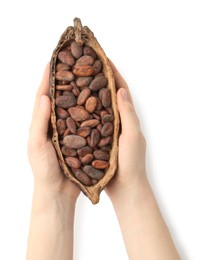 Photo of Woman holding cocoa pod with beans on white background, top view